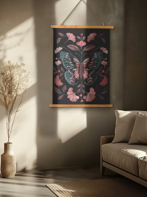 Hanging tapestry featuring a teal and pink butterfly surrounded by ginkgo-like leaves on a black background. The textile is suspended from wooden dowels with twine, creating detailed 3D embroidery-like texture.